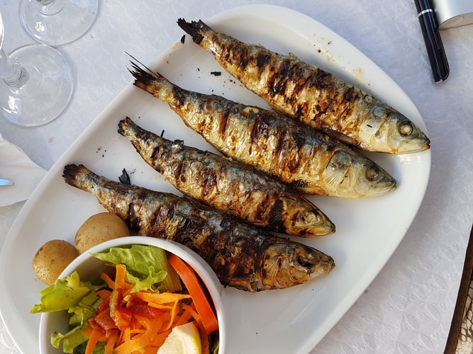 Why Portuguese Food Might Be Europe’s Most Underrated Cuisine: The Best Portuguese Foods Every Traveler Should Try 2 Sardinhas asadas, Portuguese Food, Portuguese cuisine, traditional Portuguese food, food in Portugal, Portuguese dishes