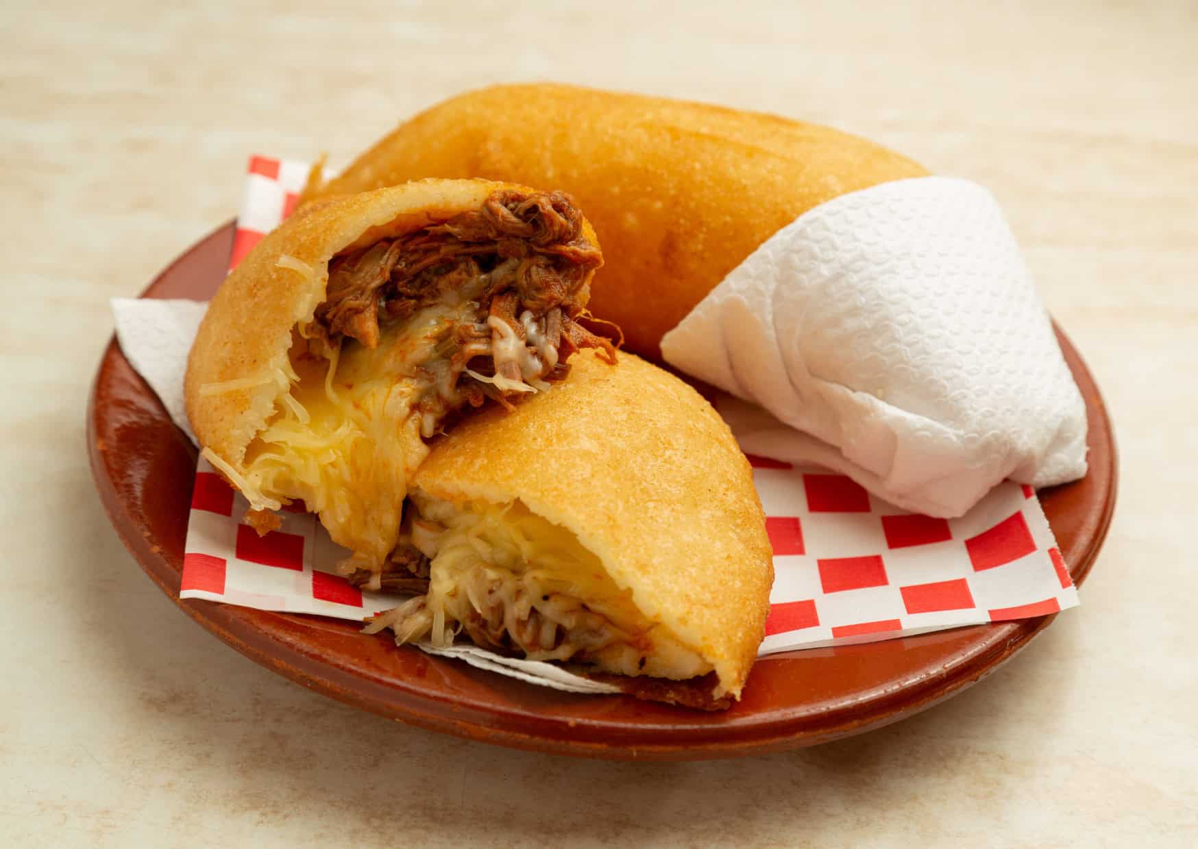 Venezuelan Empanada Peluda shredded meat with yellow cheese