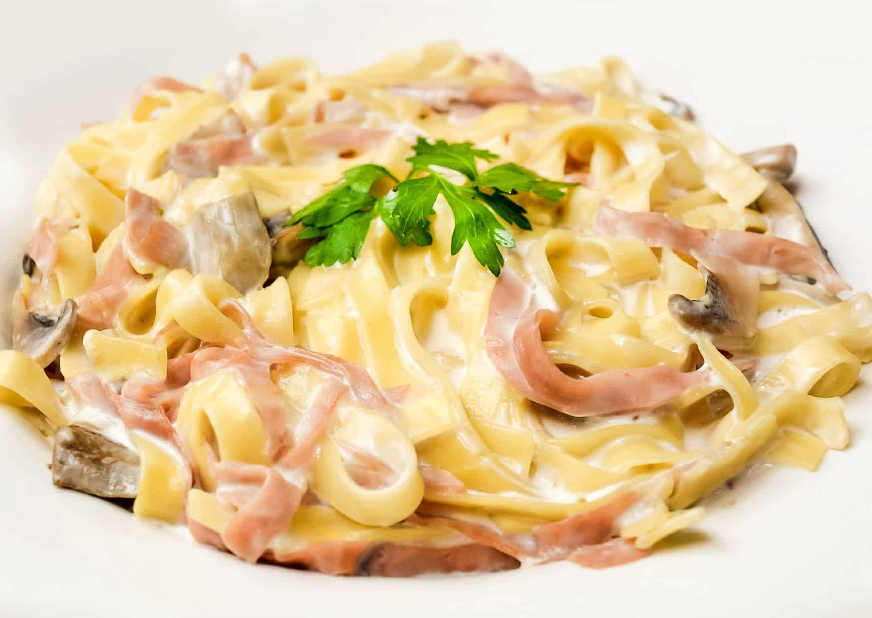 12 Italian Tagliatelle Recipes That Make Ordinary Pasta Feel Boring 10 Tagliatelle al Prosciutto e Piselli (Ham and Peas)