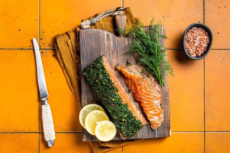 Why Mediterranean People Eat So Healthy & Which Foods They Rarely Eat 3 scandinavian gravlax salmon fillet with dill salt papper orange background top view 89816 43397