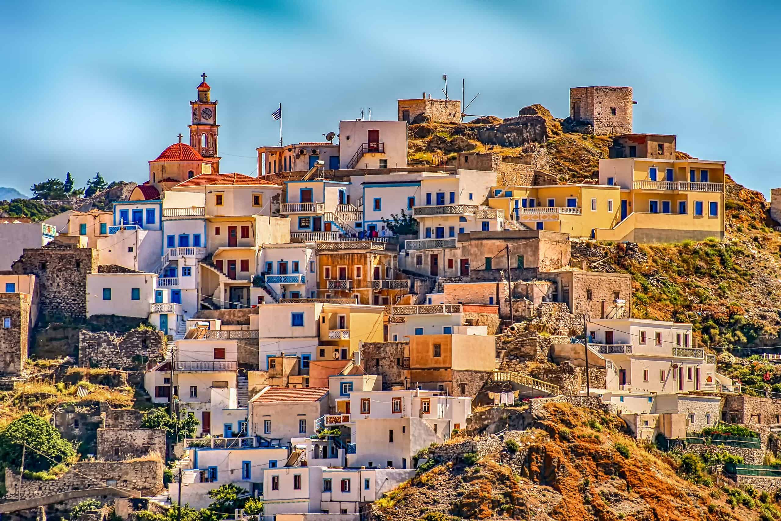 These Countries Want Retirees And A $2,000 Pension May Be Enough: 8 Countries Where A $2,000 Pension Can Get You Residency 2 Greece Village Karpathos Hill Architecture City scaled